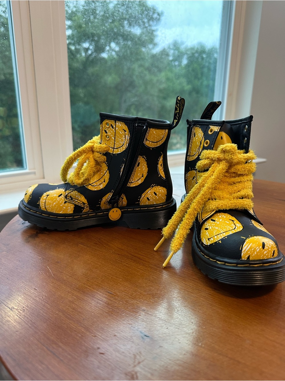 Dr. Martens Kids Black Boots with Yellow Smiley Print and Fuzzy Yellow Laces